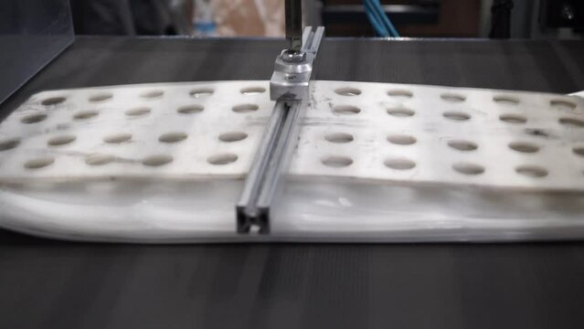 Automatic polyethylene plastic bag production machine with lighting effect.  Industrial line for the production of plastic packaging film. Factory for the production of packaging materials
