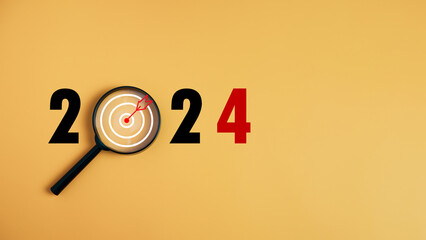 The dartboard icon in a magnifying glass centered on the number 2024 on a yellow background....