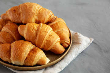 Homemade Croissants on a Plate, side view. Copy space.