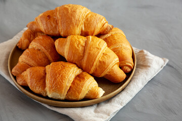 Homemade Croissants on a Plate, side view. Copy space.