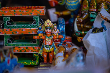 Wooden Art, Hindu god hanuman idol made on wooden with hand work and filled with natural colours at Surajkund Craft Fair. Selective focus on object.