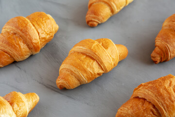 Homemade Croissants on a gray background, side view.