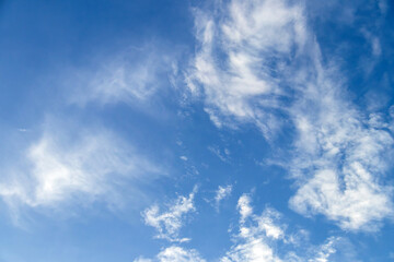 Blue sky with fluffy clouds; soft white clouds on blue sky. Skyscraper background.