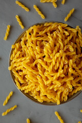 Uncooked Dry Gemelli Pasta in a Bowl, top view. Flat lay, overhead, from above.
