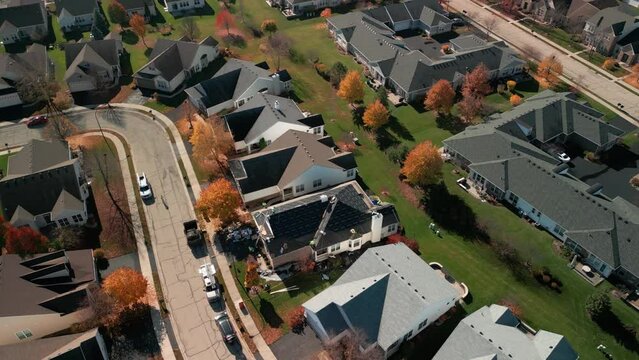 Aerial shot of Roofer repair or replace shingle that has been damaged and needing replacement at sunny day. 