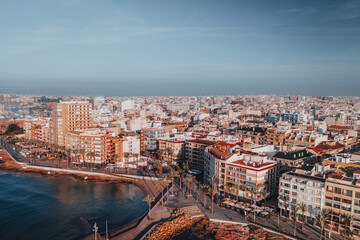 Obraz premium Unique angle captures Torrevieja's village allure, pristine beach, and lively waterfront. This fresh perspective highlights the Spanish town's coastal charm, blending its historic roots with seaside