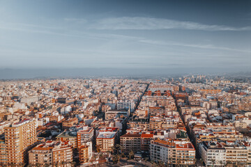 Fototapeta premium Aerial shot of Torrevieja, Spain, at sunrise. The Mediterranean's waters shimmer, reflecting golden sun rays. The coastal town awakens, bathed in morning light, exuding an unmatched serene beauty.