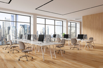 Modern office coworking interior with pc monitors and chairs in row, window
