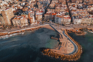 Aerial perspective of Torrevieja reveals a harmonious blend of village charm, pristine beach, and vibrant waterfront. From above, the Spanish town's diverse beauty unfolds.