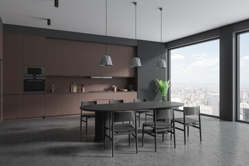 Gray and brown kitchen corner with cabinets and dining table