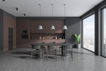 Gray and brown kitchen interior with cabinets and dining table