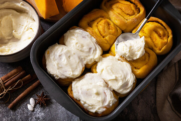 Homemade seasonal autumn homemade pastry. Freshly baked pumpkin cinnamon rolls or cinnabon with...