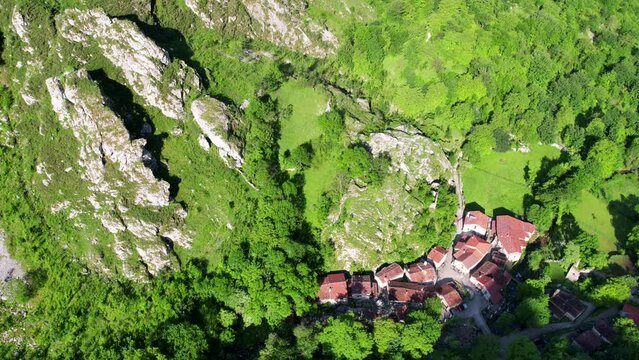 Aerial flyover view above the the village of Bulnes in the Picos de Europa in Spain	