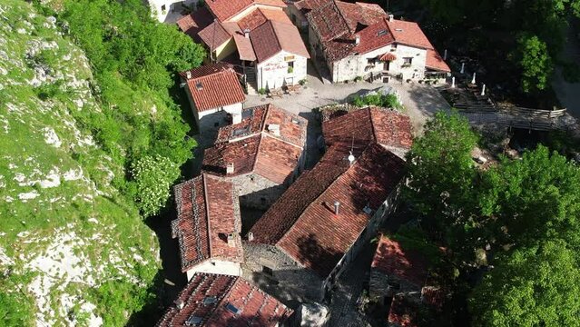 Aerial flyover view above the the village of Bulnes in the Picos de Europa in Spain	