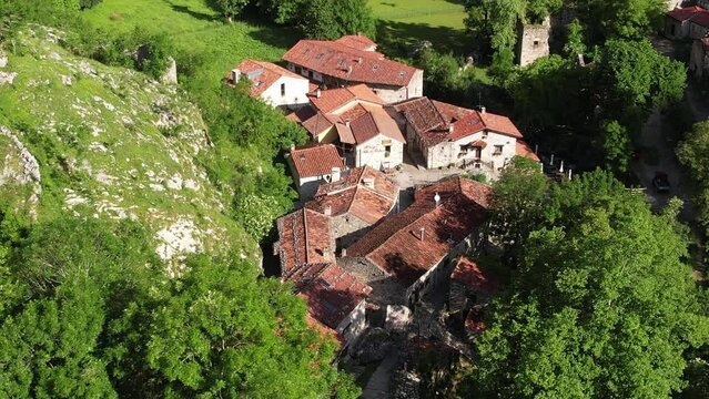 Aerial flyover view above the the village of Bulnes in the Picos de Europa in Spain	