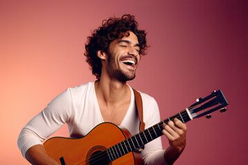 Happy man laughs while playing a Spanish guitar against a magenta gradient background.