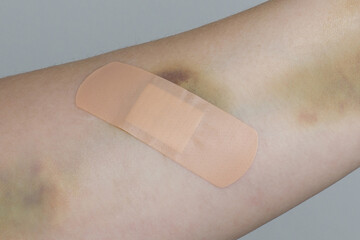 Human hand with a band aid closeup