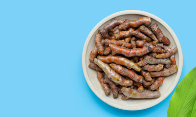 Curcuma or turmeric on blue background.