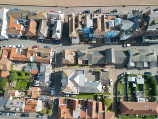 Drone top down view of a famous Suffolk coastal town. Showing both terraced townhouses and separate dwellings. The beach can be seen at the top.
