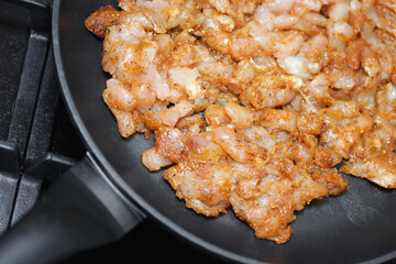 Making turkish doner kebab at home. Raw chicken pieces on frying pan. Marinated chicken in spices. Gyros dish recipe. Dinner frying background. Simple meat background.