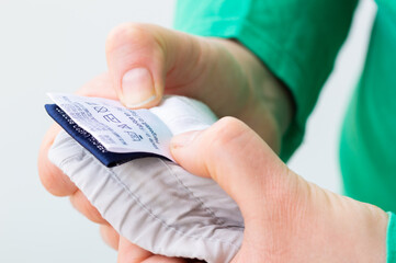 Close-up of person reading the clothing label showing washing instructions at home.