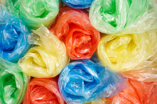 top view of colorful folded plastic bag in yellow, red, blue and green color, environmental concept