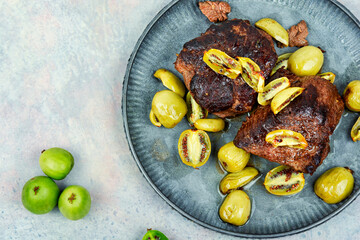 Grilled ostrich steak with kiwi berries