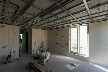 Drywall installation work in progress by construction workers at construction room. easiest and...