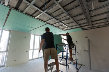 Fototapeta premium Construction worker ceiling work installation