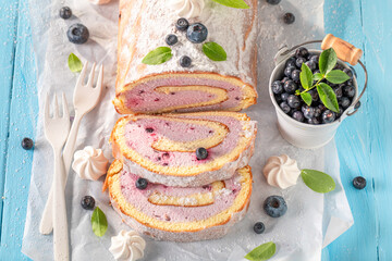 Homemade blueberry swiss roulade made of berry fruits.