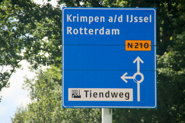 Fototapeta premium Blue direction sign on N210 road heading to Rotterdam