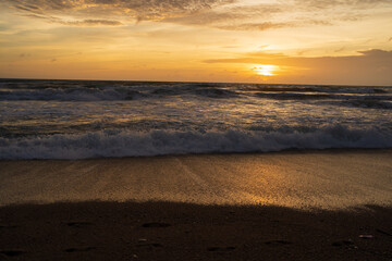 Beautiful sunset above sea, Colorful Orange and golden sunset sky.