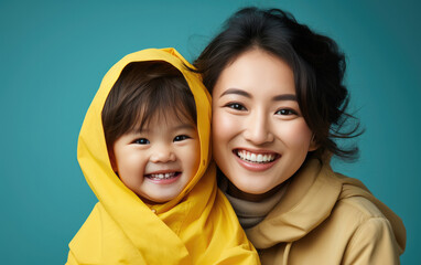 Obraz premium happy vogue fashion mother wearing lovingly embracing her kid, Bright solid light background