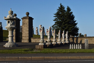 The interesting unique contrast of the small buddha statues with the stone Moai statues in Sapporo Japan