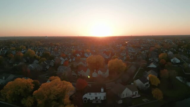 Wide Drone shot footage. American new suburb at autumn. Establishing shot of neighborhood at sunset