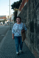 Fototapeta na wymiar A mature woman is walking down the street.