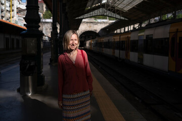 A woman waiting at a railway station.