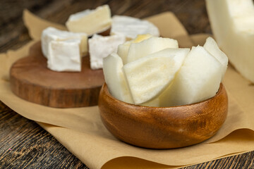 soft processed cheese on a board and paper