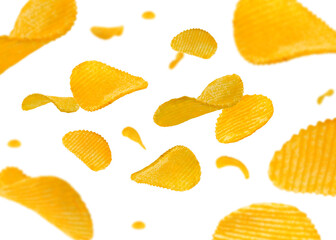 Ridged potato chips isolated on white fly and levitate in space. Selective focus