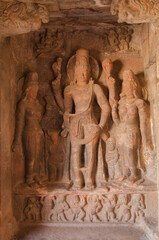 Harihar form and Gandharva and Apsara on the roof, Badami cave temple, Badami, Karnataka, India.