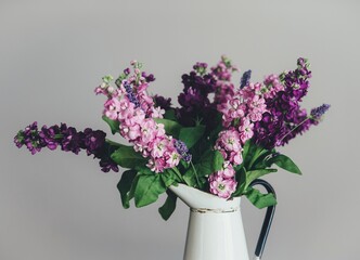 Purple flowers in a vase. Original public domain image from Wikimedia Commons