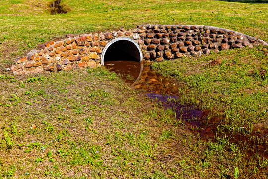 Description
Concrete culvert forming a grassy bridge over a drainage ditch with rock cladding near Riversdale in the Western Cape, South Africa