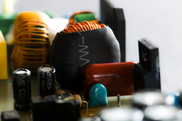 Electronic circuit closeup from low angle. LED light circuit board with capacitors and electrical...