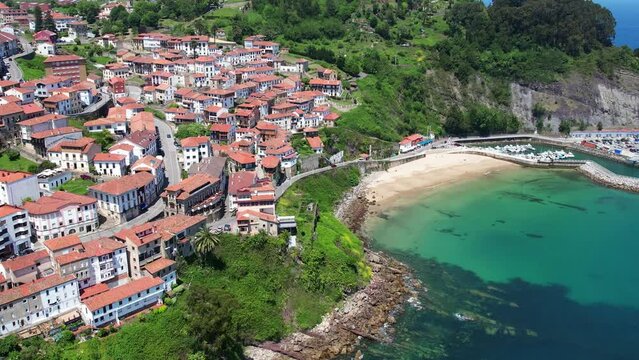 Aerial flyover above the beautiful seaside village of Llastres in the costa Verde of northern Spain