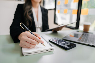 businesswoman working with digital tablet computer and smart phone with financial business strategy layer effect on desk .