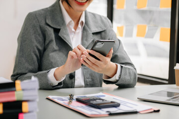 businesswoman working with digital tablet computer and smart phone with financial business strategy layer effect on desk .