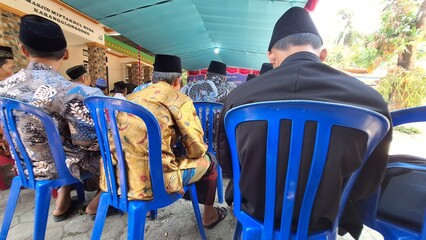 photos of people wearing caps sitting on plastic chairs