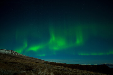 Fototapeta na wymiar aurora borealis over the mountains