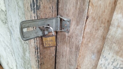wooden door locked with a padlock