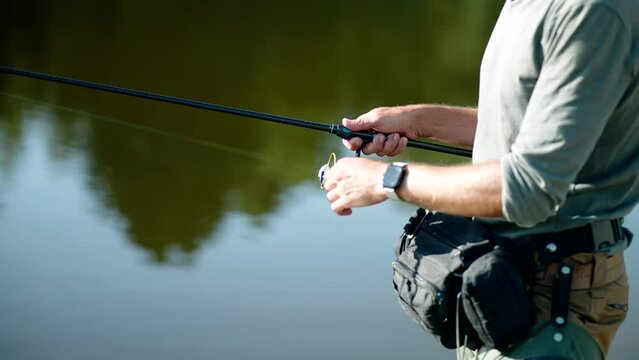 angler catching fish with light rod